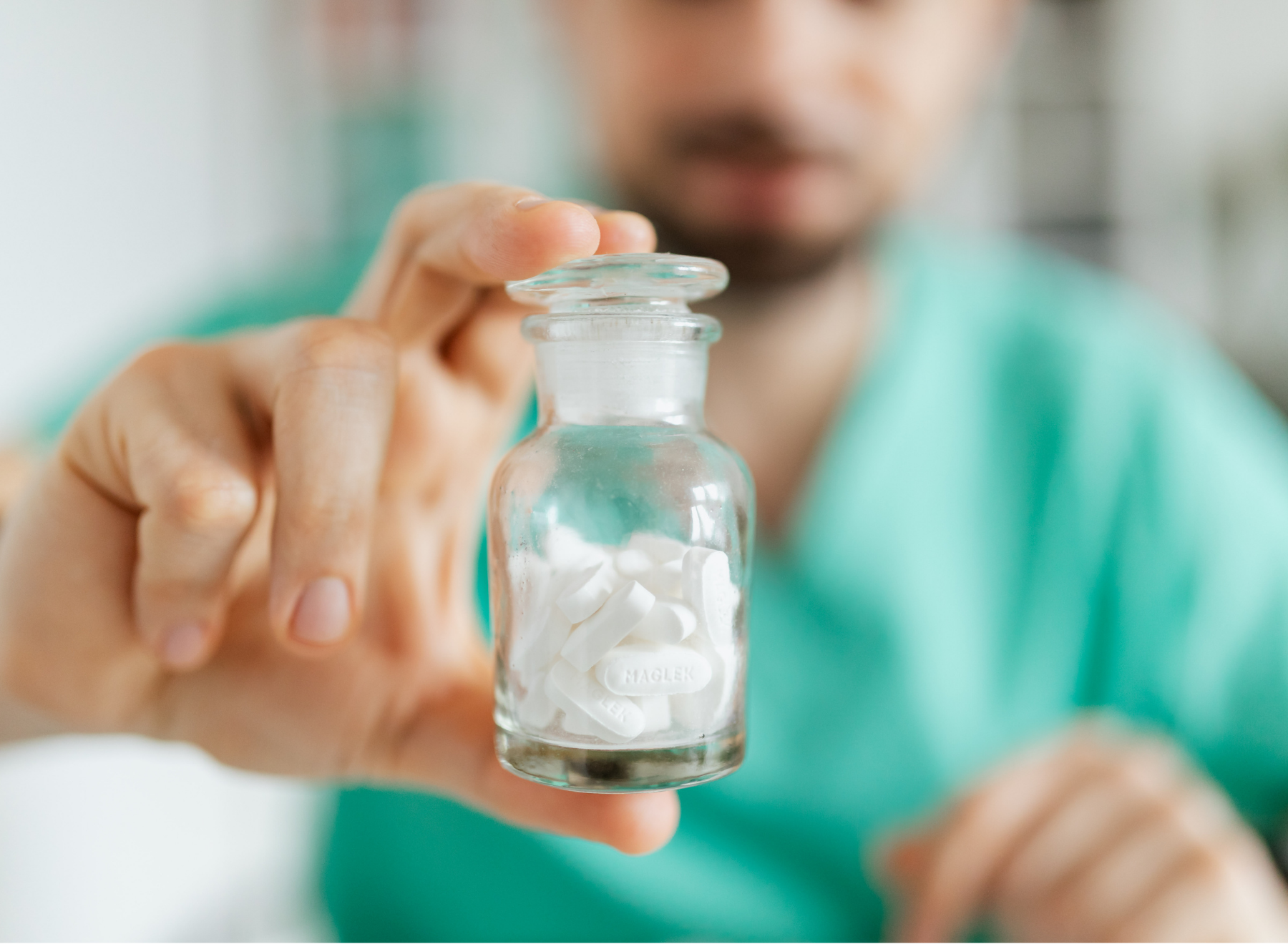 pharmacist holds up bottle of medications