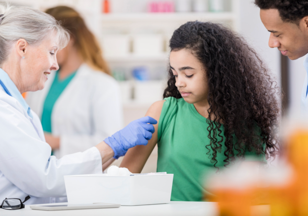 girl receiving vaccine in arm 