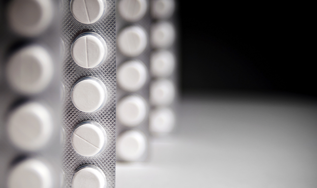 standing pill packs on black background