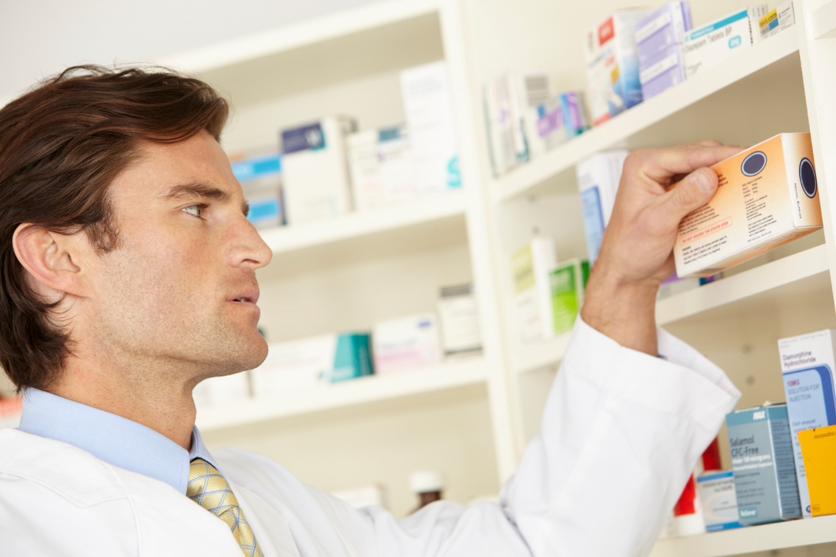 pharmacist looking at medication box
