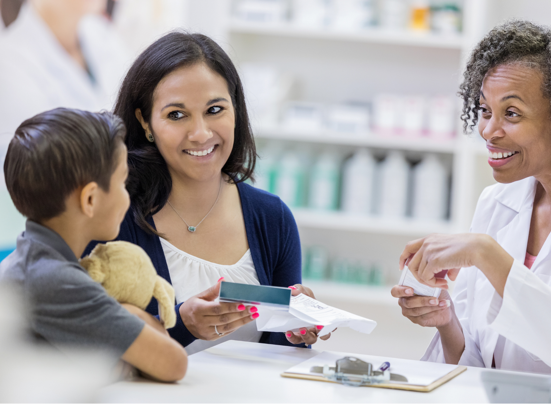 patient and son speak with a pharmacist