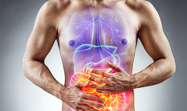 man clutching stomach with digestive system illustration
