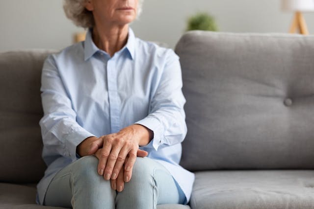 elderly woman sitting on a couch