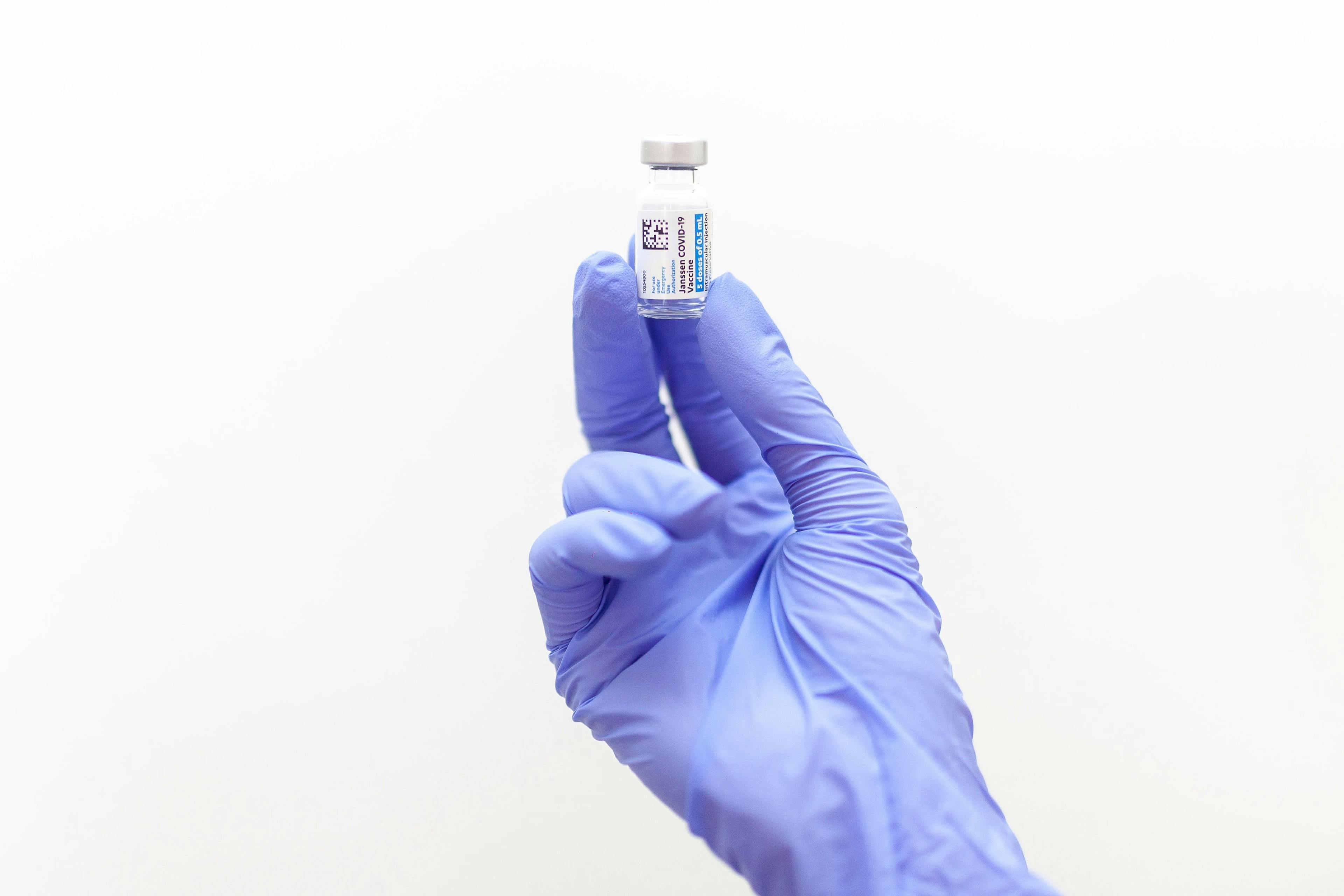 researcher holds Janssen COVID-19 vaccine