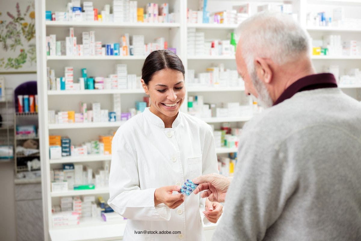 female pharmacist speaks to older patient