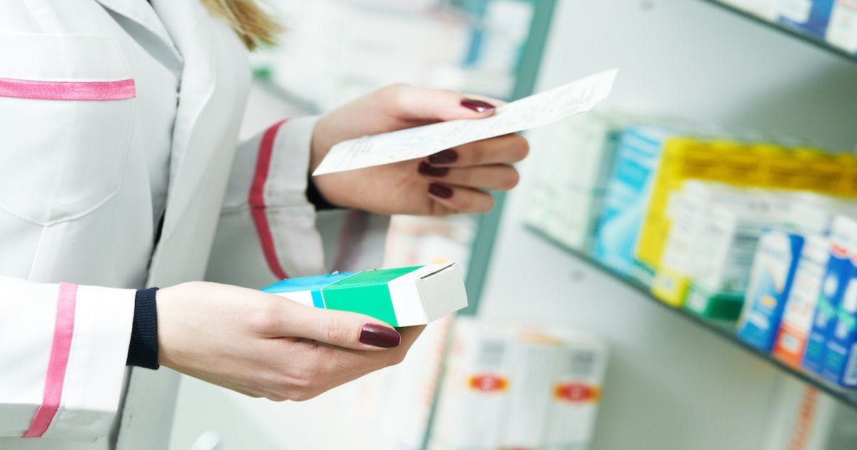 Pharmacist holding prescription