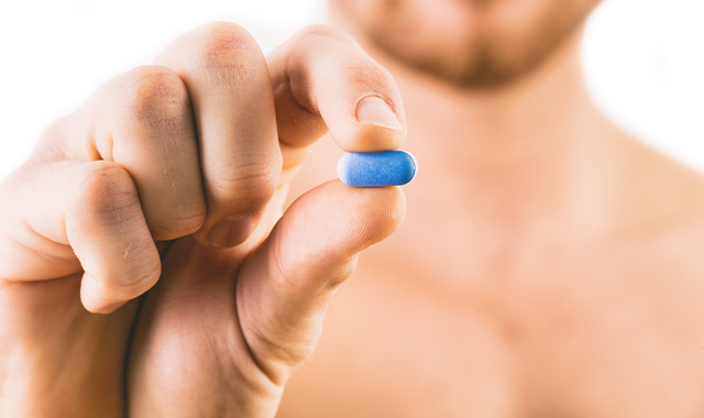 man holding blue pill