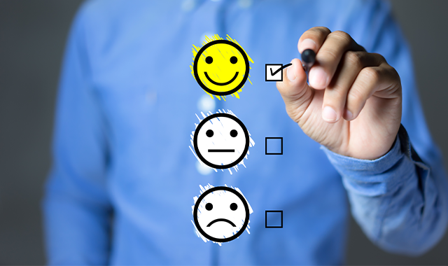 man selecting smily face on survey 