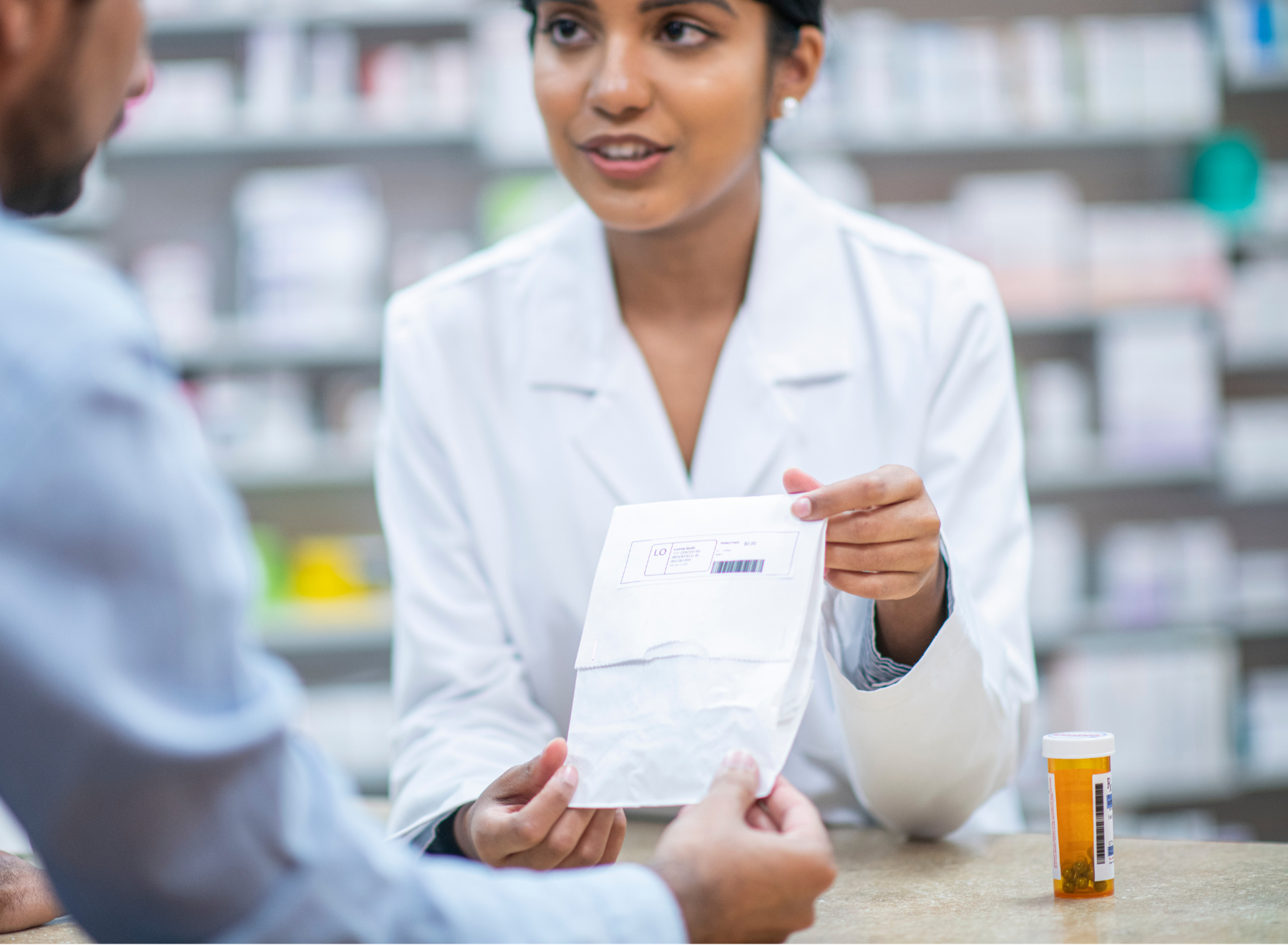 pharmacist holds prescription packet